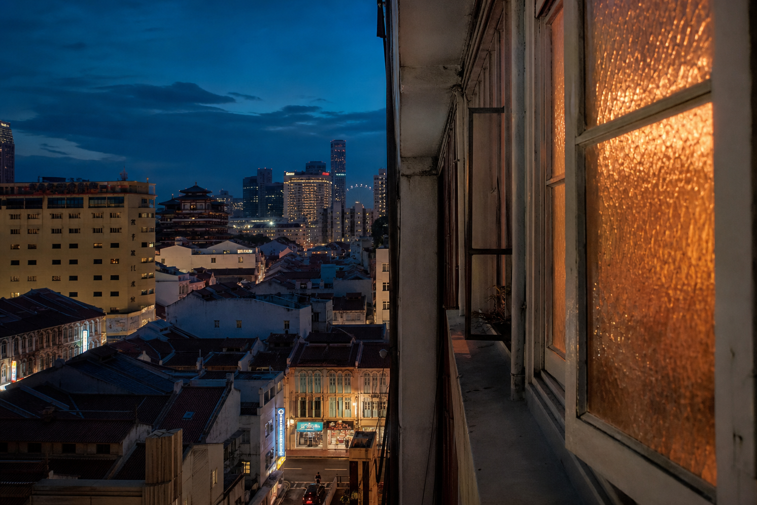 Evening view from a high corridor window over Chinatown shophouse rooftops