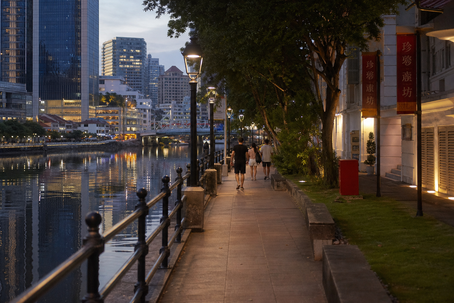 Walking path along the Singapore River with railings and evening reflections